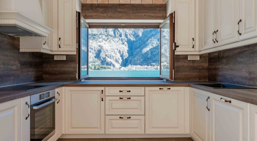 Stone house on the bay with a boat dock, Muo