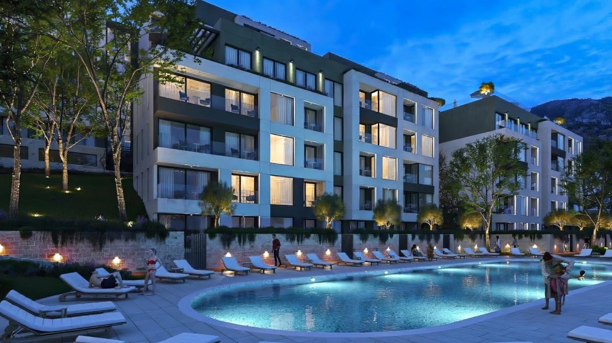 Stan sa 2 spavaće sobe u modernom stambenom kompleksu u izgradnji sa bazenima i parkingom, Tivat